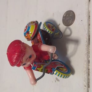 Vintage mechanical toy, boy on a bike.